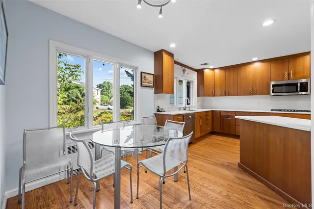 a kitchen with a table chairs sink and cabinets