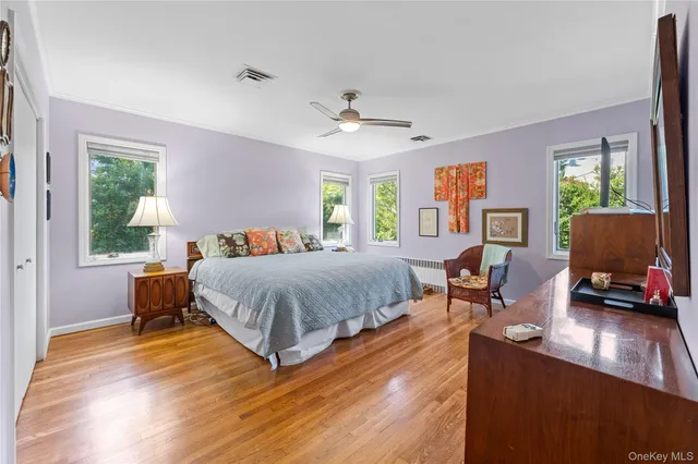 a bedroom with a bed window and a desk