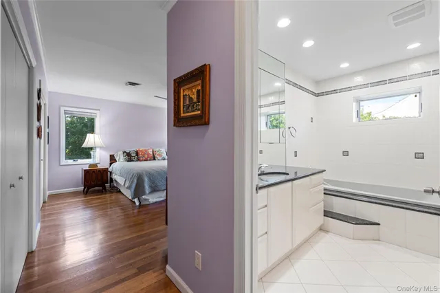 a spacious bedroom with a bed and a view of bathroom