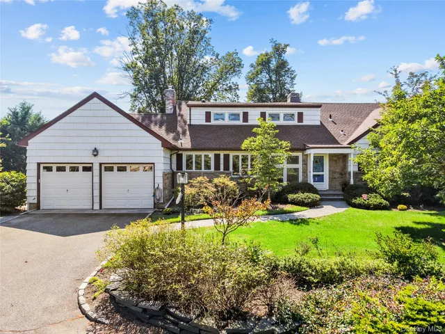 a view of a house with a yard patio and a garden