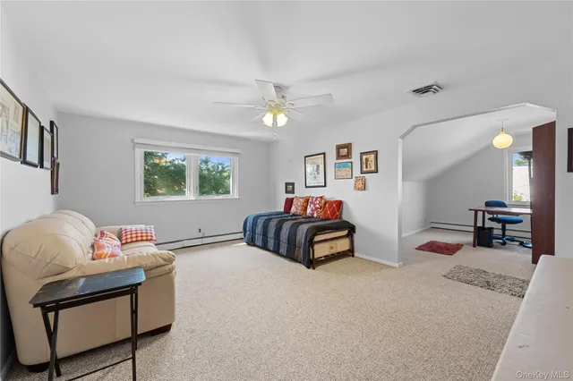 a bedroom with furniture and a window