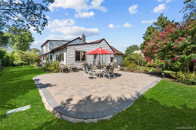 a view of a house with backyard porch and garden