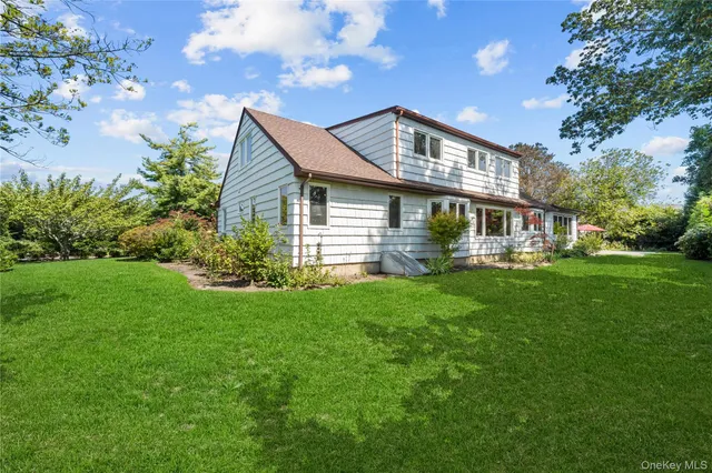 a front view of house with yard and green space