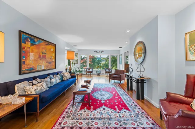 a living room with furniture a rug and a large window