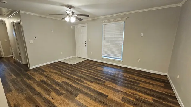a view of a livingroom with wooden floor and a ceiling fan