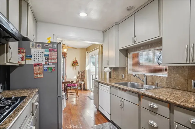 a kitchen with granite countertop lots of counter top space and stainless steel appliances