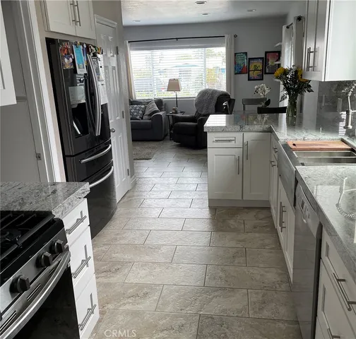 a kitchen with kitchen island a counter top space appliances and a window
