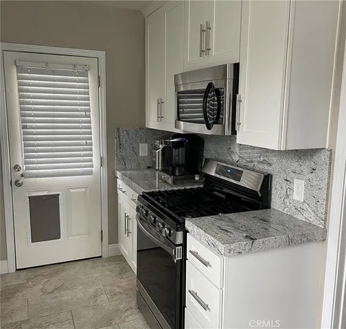 a stove top oven sitting inside of a kitchen