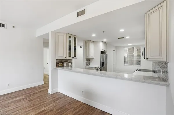 a kitchen with stainless steel appliances granite countertop a sink and cabinets
