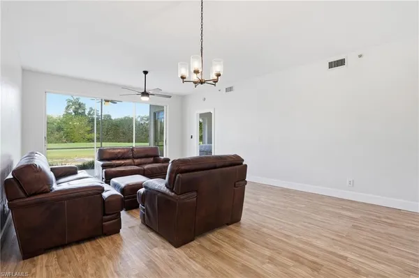 a living room with furniture and a chandelier