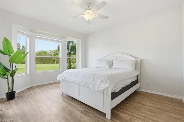 a bedroom with a bed and a potted plant