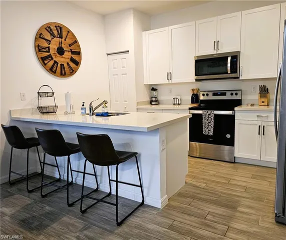 a kitchen with a stove a sink and a microwave