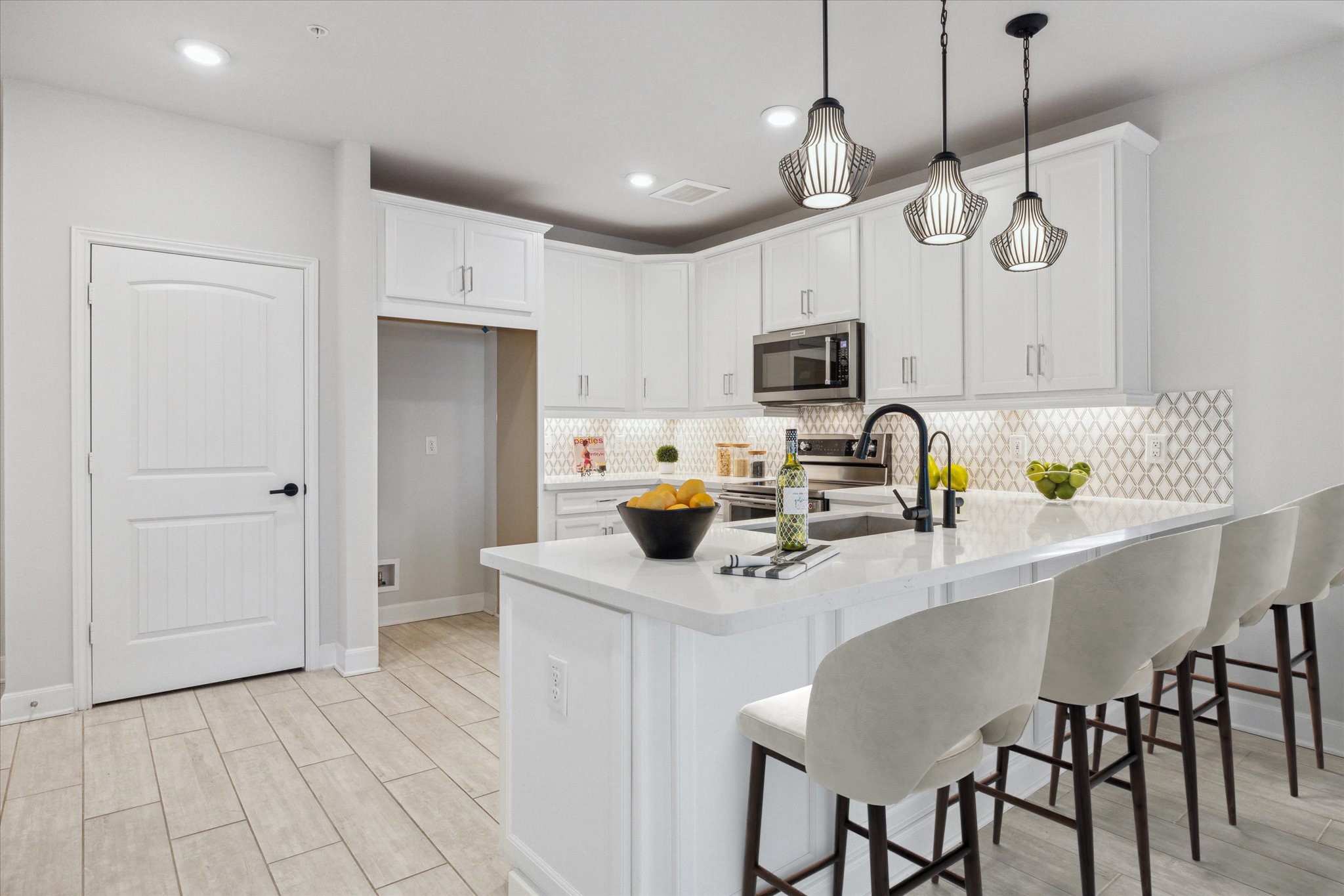6804 Westview Drive, Unit 1407 Houston, TX 77055 - Photo 4 of 31 Virtually Staged. Gorgeous kitchen with quartz countertops, shaker style cabinetry, under-cabinet lighting, and a breakfast bar with pendant lighting.