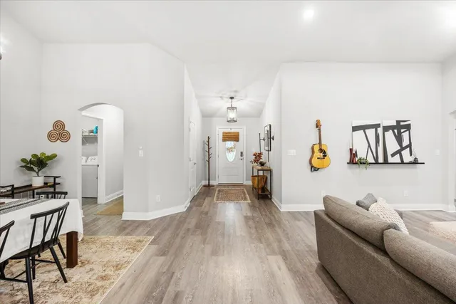 a living room with furniture and wooden floor
