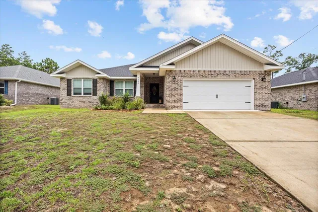 a front door view of a house with a yard