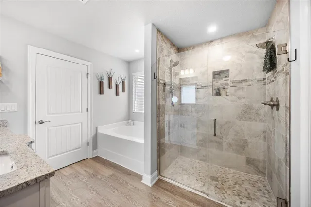 a bathroom with a bathtub and a shower