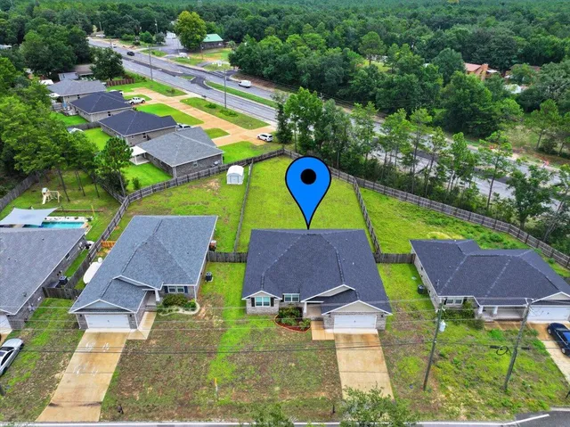 an aerial view of residential houses and swimming pool