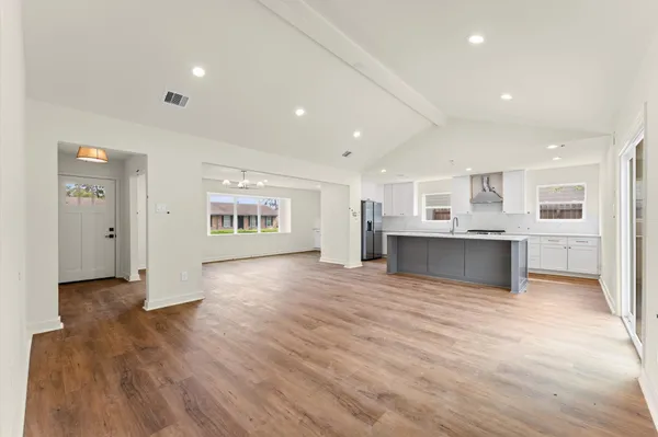 a view of kitchen with a sink cabinets and wooden floor