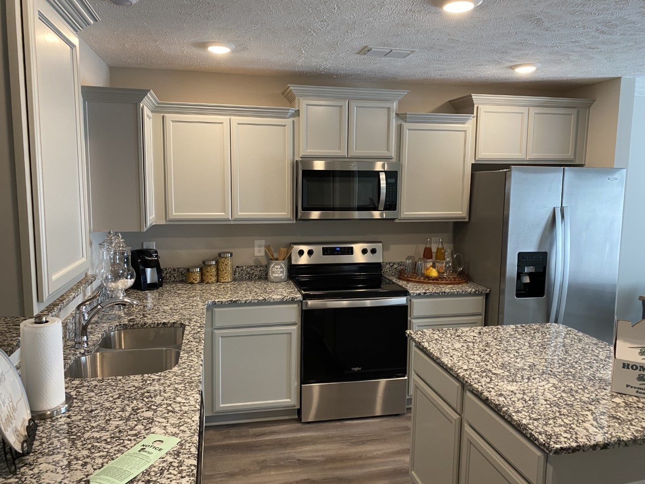 317 Ezra Street Pleasant View, TN 37146 - Photo 4 of 11 a kitchen with stainless steel appliances granite countertop a sink stove microwave and refrigerator
