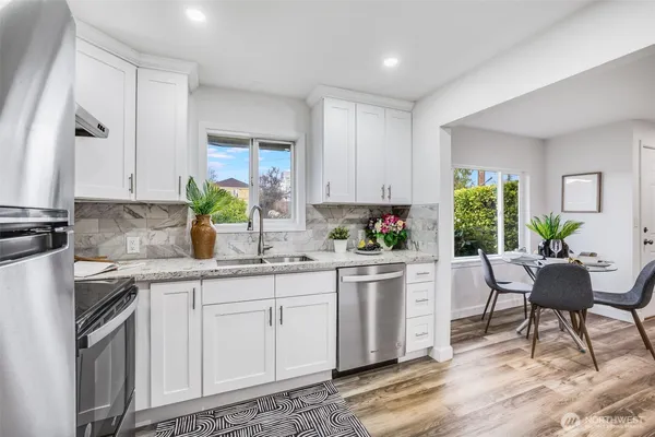 a kitchen with a sink cabinets and window