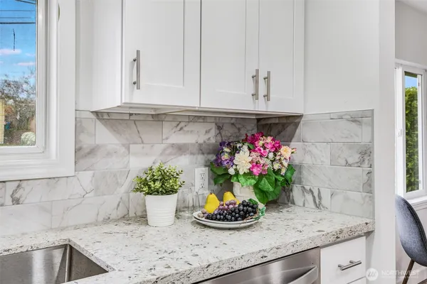 a kitchen with a potted plant on the counter
