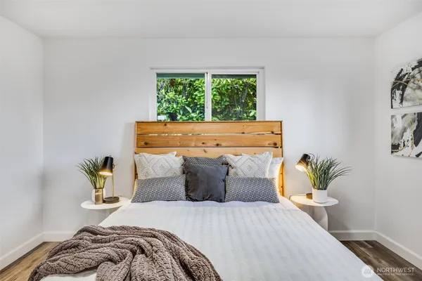 a bed sitting in a bedroom next to a window