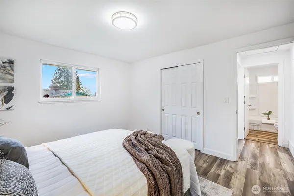 a bedroom with a bed and painting on the wall