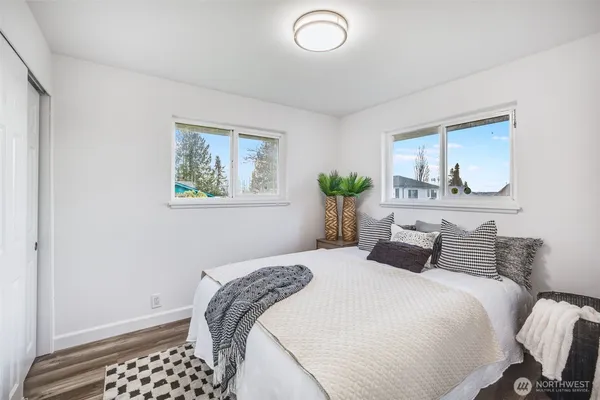 a bedroom with a large bed and a window