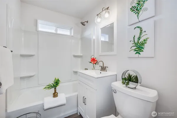 a white sink sitting next to a white toilet