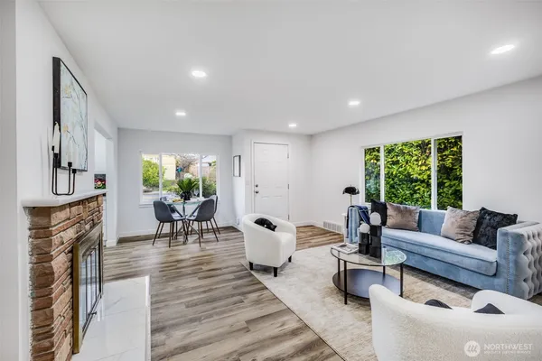 a living room with furniture a fireplace and a table
