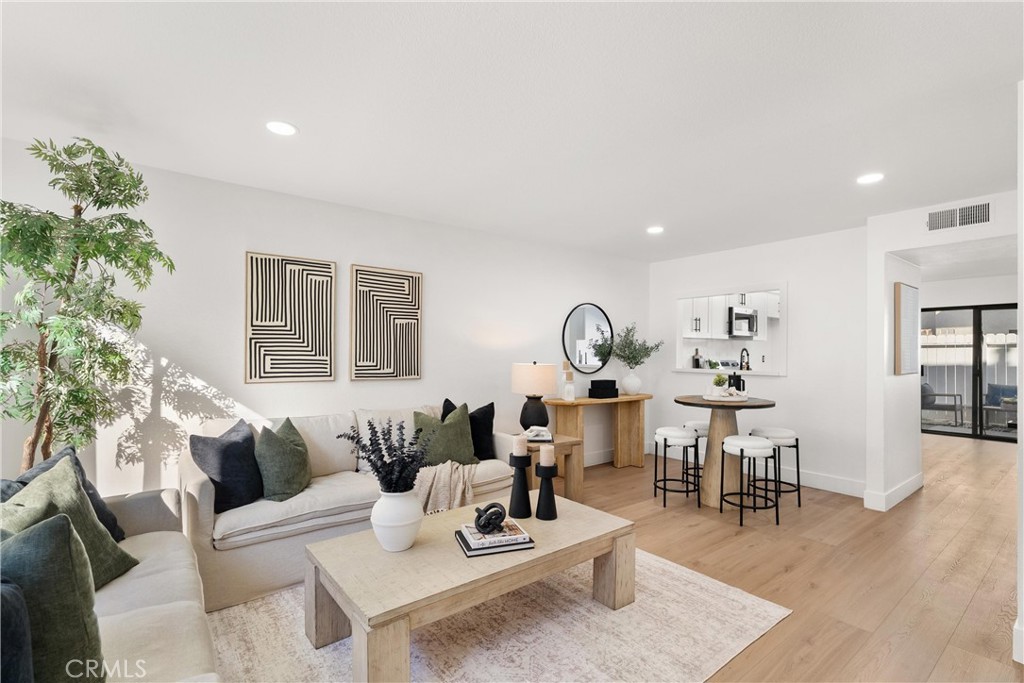 25885 Trabuco Road, Unit 91 Lake Forest, CA 92630 - Photo 1 of 36 a living room with furniture and wooden floor