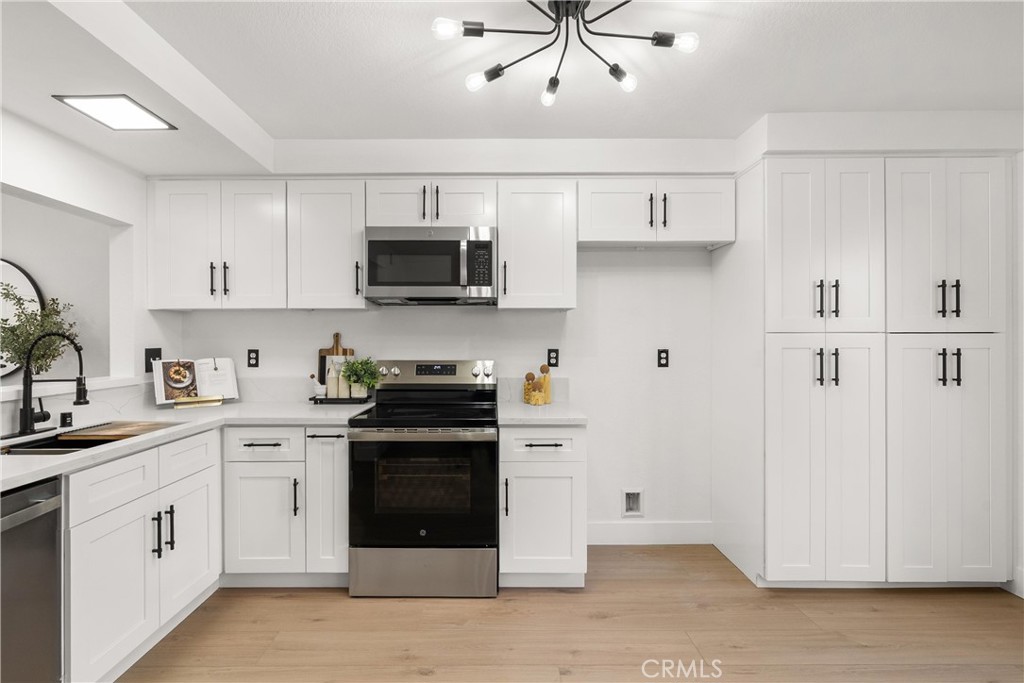 25885 Trabuco Road, Unit 91 Lake Forest, CA 92630 - Photo 11 of 36 a kitchen with cabinets stainless steel appliances and a counter space