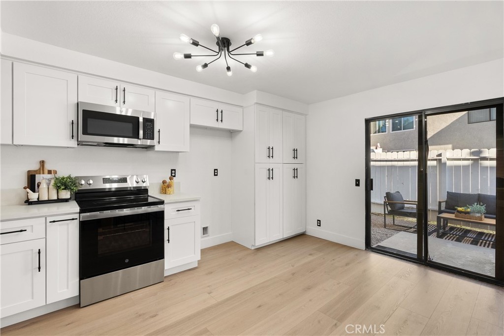 25885 Trabuco Road, Unit 91 Lake Forest, CA 92630 - Photo 12 of 36 a kitchen with stainless steel appliances granite countertop a stove and a refrigerator
