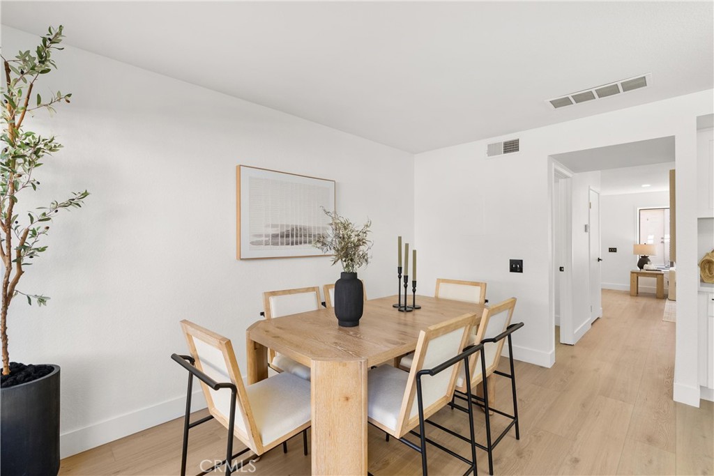 25885 Trabuco Road, Unit 91 Lake Forest, CA 92630 - Photo 13 of 36 a view of a dining room with furniture and wooden floor