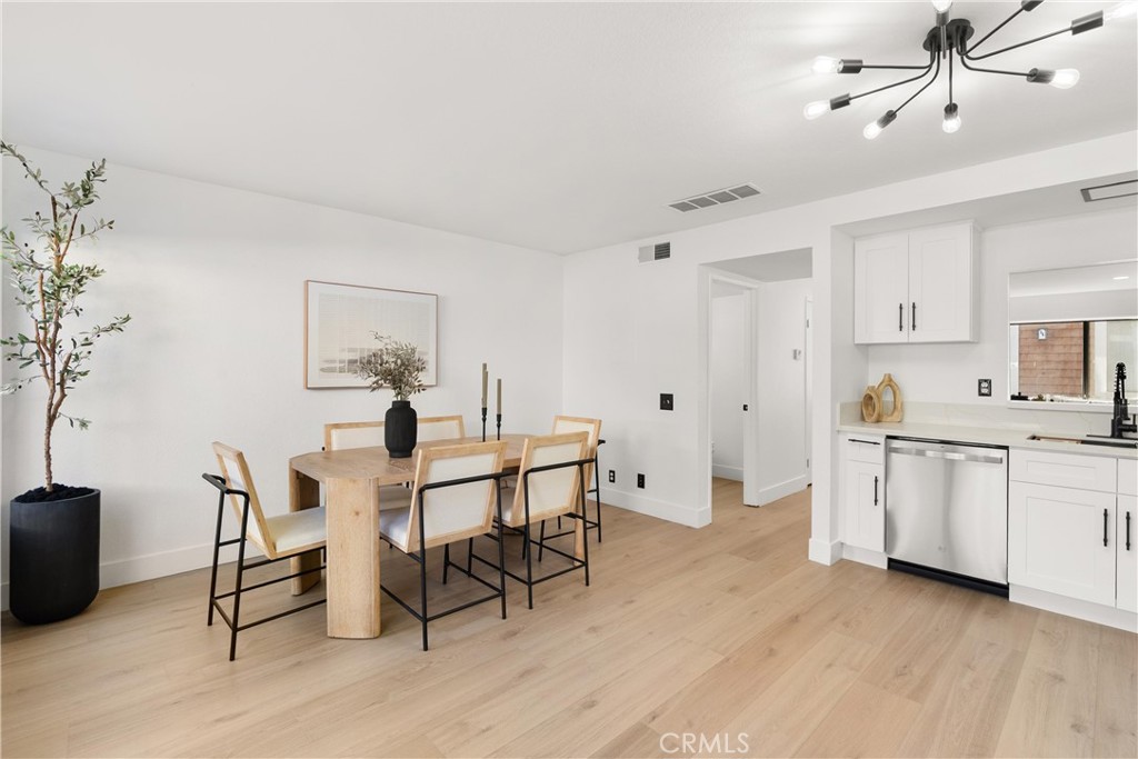 25885 Trabuco Road, Unit 91 Lake Forest, CA 92630 - Photo 14 of 36 a view of a dining room with furniture and wooden floor