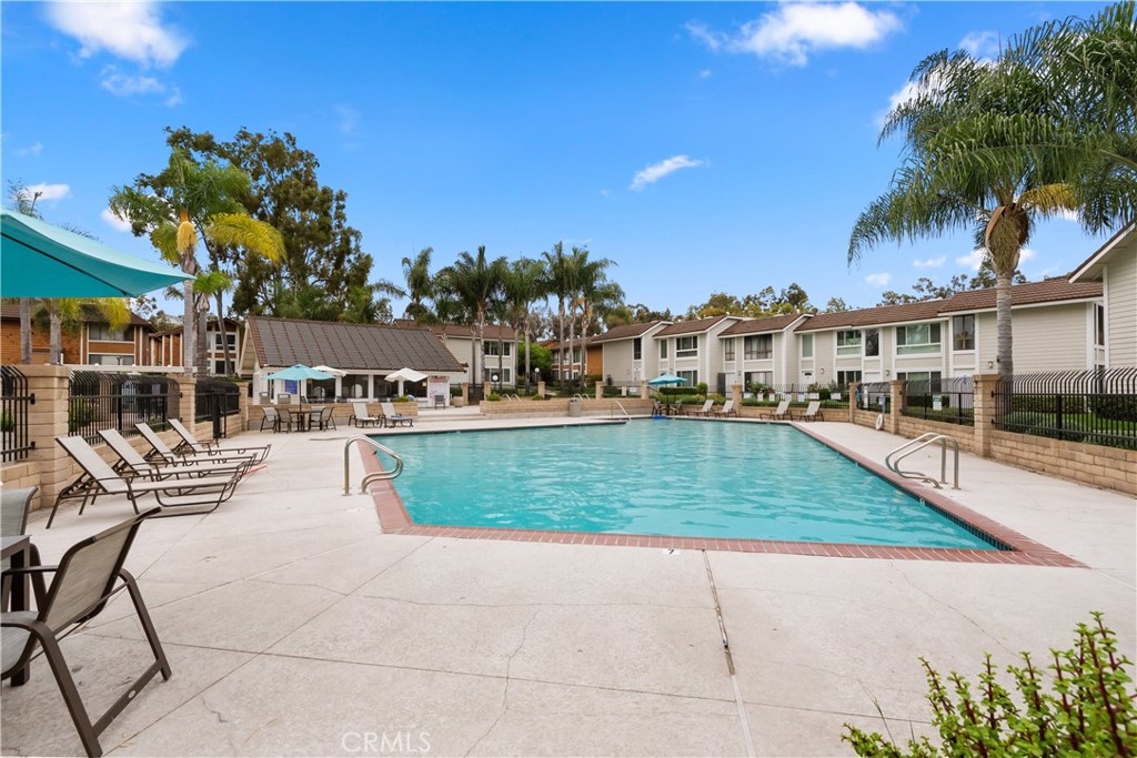 25885 Trabuco Road, Unit 91 Lake Forest, CA 92630 - Photo 30 of 36 a view of swimming pool with outdoor seating and trees in the background