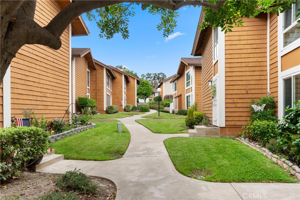 25885 Trabuco Road, Unit 91 Lake Forest, CA 92630 - Photo 33 of 36 a view of a white building with a yard and plants