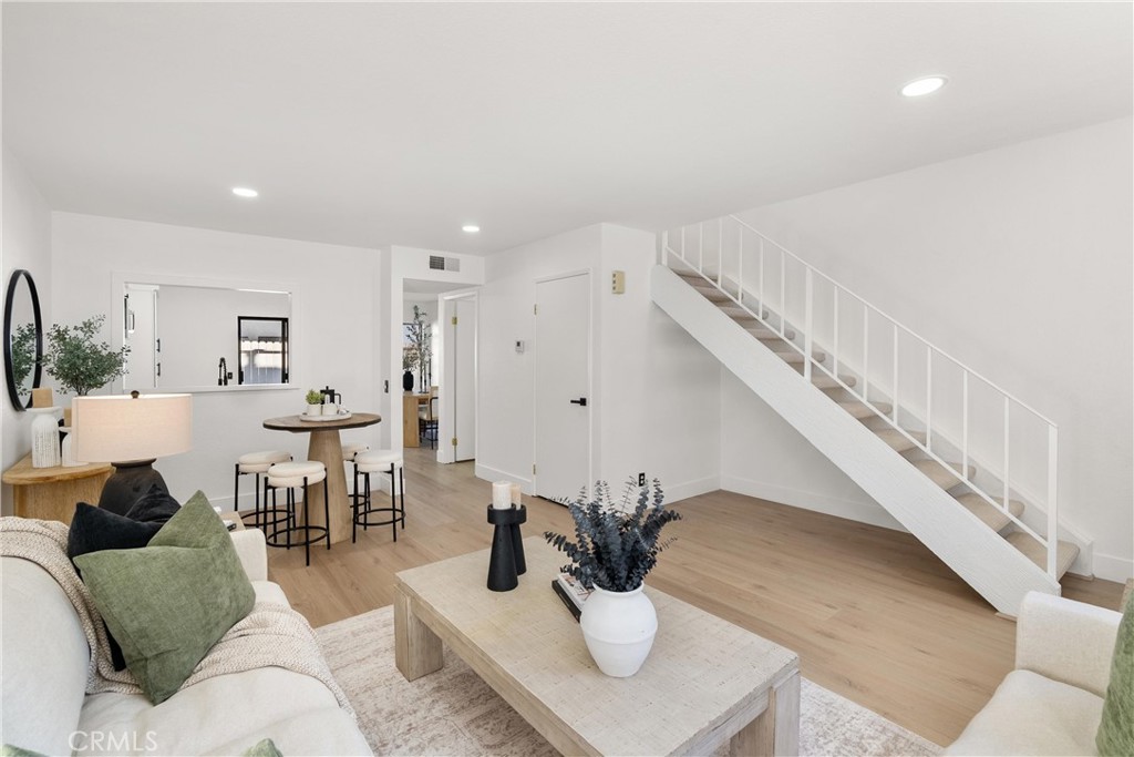 25885 Trabuco Road, Unit 91 Lake Forest, CA 92630 - Photo 4 of 36 a living room with furniture couches and a dining table with wooden floor