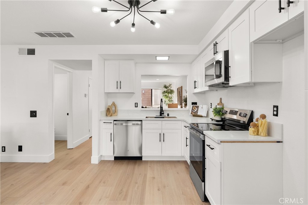 25885 Trabuco Road, Unit 91 Lake Forest, CA 92630 - Photo 9 of 36 a kitchen with stainless steel appliances a sink stove and refrigerator