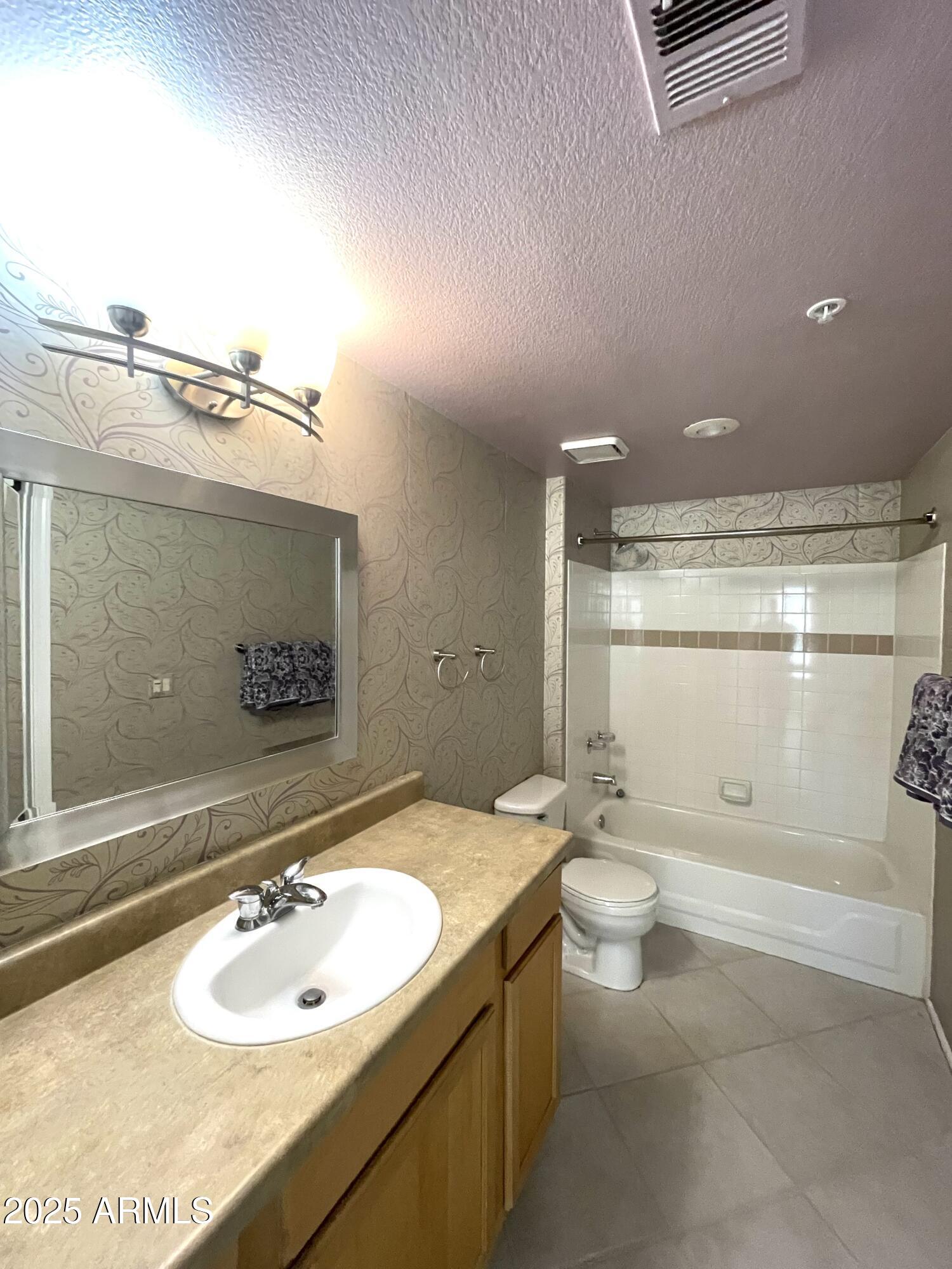 750 East Northern Avenue, Unit 1047 Phoenix, AZ 85020 - Photo 14 of 19 a bathroom with a sink a toilet and shower