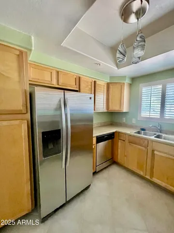a large kitchen with cabinets and stainless steel appliances