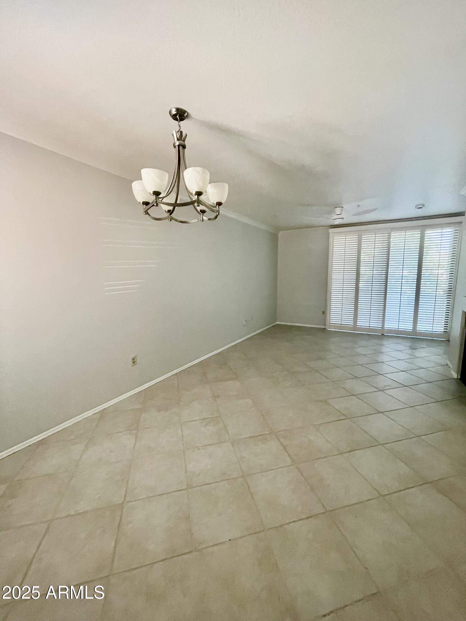 750 East Northern Avenue, Unit 1047 Phoenix, AZ 85020 - Photo 6 of 19 a view of a room with a chandelier fan and kitchen view