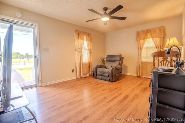 a spacious bedroom with a bed and wooden floor