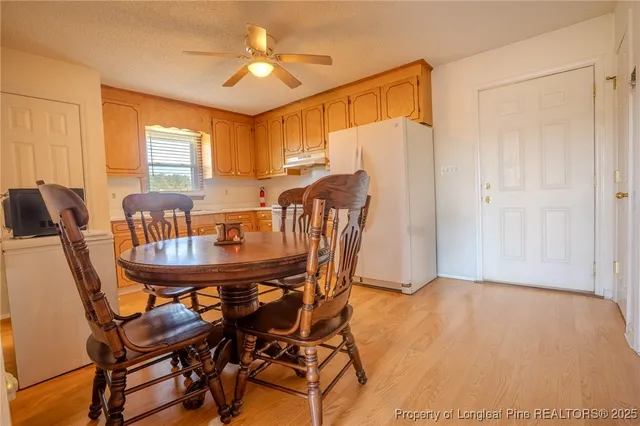a view of a dining room with furniture and window