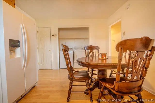 a dining room with furniture and wooden floor