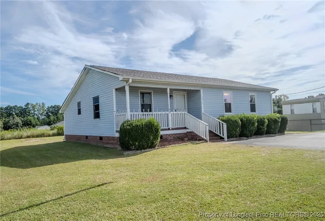 a view of a house with patio and garden