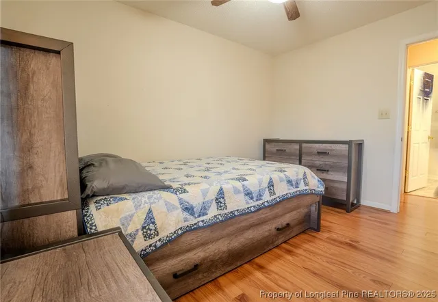 a bedroom with a bed and wooden floor
