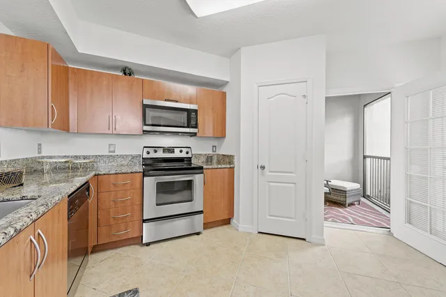 a kitchen with a refrigerator stove and white cabinets