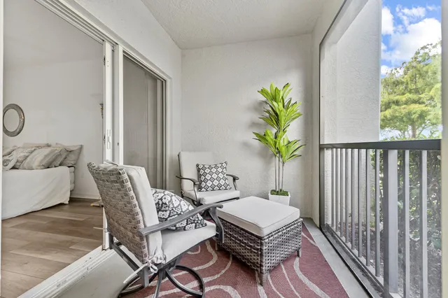 a balcony with furniture and a potted plant