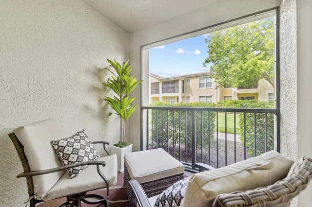 a view of a room with furniture and a window